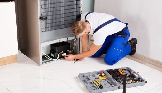 Male Technician Checking Refrigerator