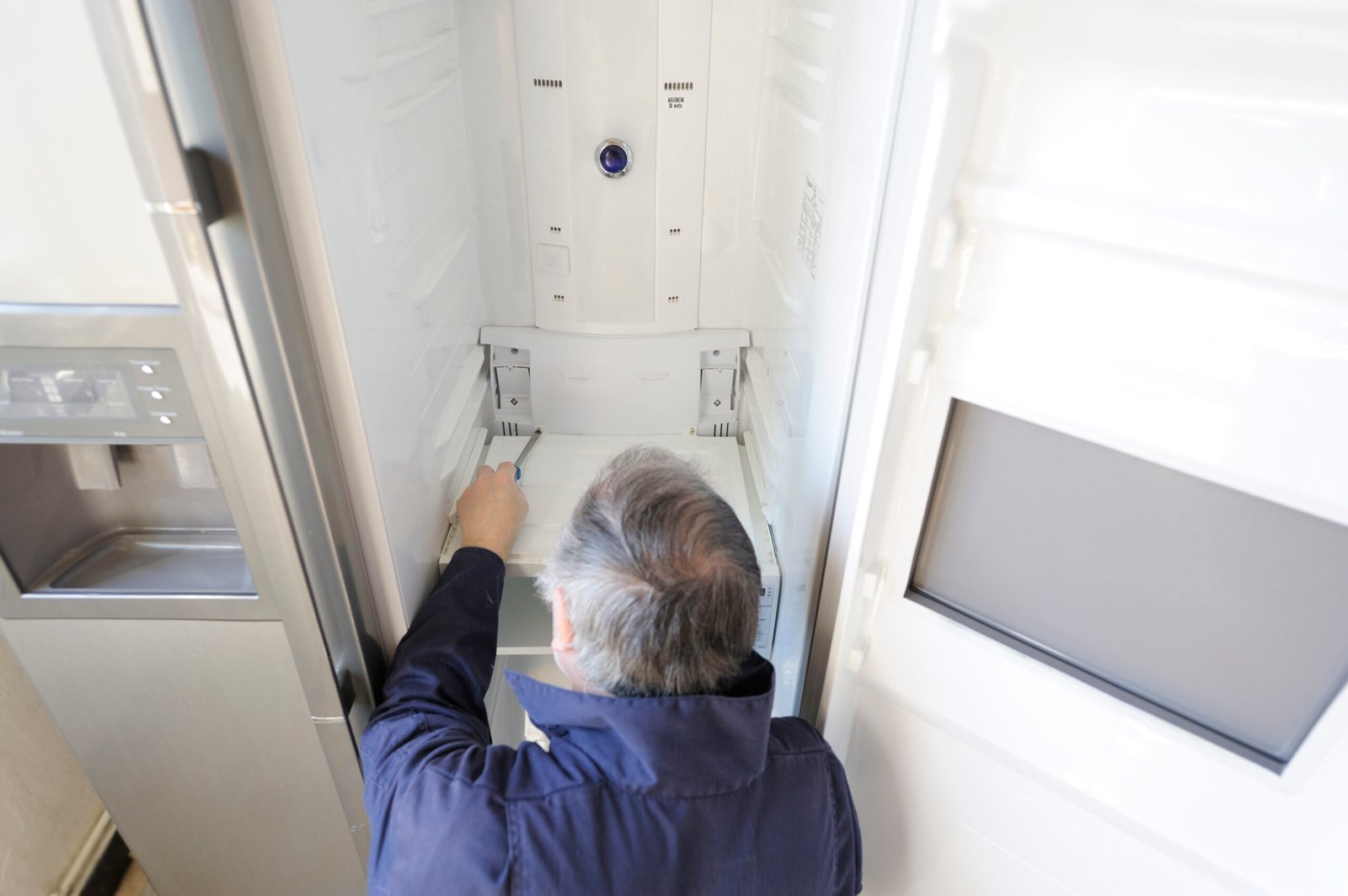 Man repairing refrigerator
